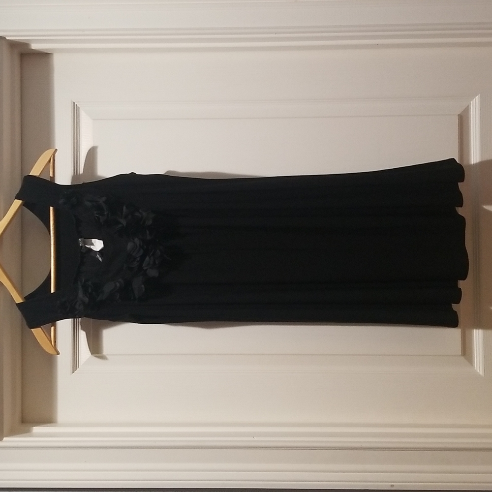 Black sleeveless stretchy dress with floral fabric around neckline